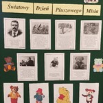 Tablica z napisem 25 listopada Światowy Dzień Pluszowego Misia. Na tablicy kartki z historią powstania święta i portrety czterech misiów