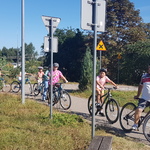 Instruktor zatrzymał się przed znakiem drogowym, za nim zatrzymały się dzieci