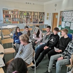 Uczeń klasy 7 B odpowiada na pytania po niemiecku na tle grupy z innowacji